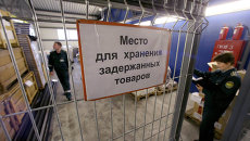 Работники таможенного поста на складе задержанных товаров. Архивное фото Работники таможенного поста на складе задержанных товаров. Архивное фото