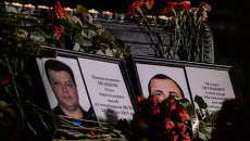 Портреты погибших в Сирии подполковника Олега Пешкова и матроса Александра Позынича. Архивное фото Портреты погибших в Сирии подполковника Олега Пешкова и матроса Александра Позынича. Архивное фото