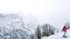 Сноубордист скатывается с горы Чегет. Архивное фото Сноубордист скатывается с горы Чегет. Архивное фото