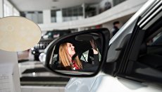 Посетительница в автосалоне. Архивное фото Посетительница в автосалоне. Архивное фото
