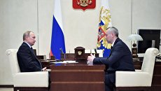 Президент РФ Владимир Путин и временно исполняющий обязанности губернатора Новосибирской области Андрей Травников во время встречи. 2 июля 2018 Президент РФ Владимир Путин и временно исполняющий обязанности губернатора Новосибирской области Андрей Травников во время встречи. 2 июля 2018