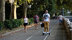 Туристы на набережной реки Сочи. Архивное фото Туристы на набережной реки Сочи. Архивное фото
