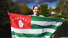 Девушка с национальным флагом Абхазии. Архивное фото Девушка с национальным флагом Абхазии. Архивное фото