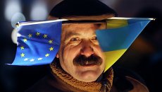 Участник митинга в поддержку евроинтеграции Украины в Киеве. 27 ноября 2013 Участник митинга в поддержку евроинтеграции Украины в Киеве. 27 ноября 2013